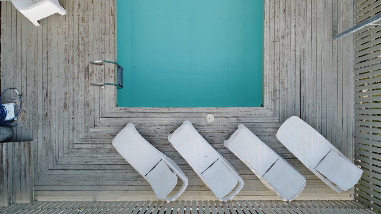 about-us Top-down view of sunbeds and a small pool in Ta'oz, Israel, perfect for summer relaxation imagery.